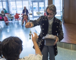 Attila Mosolygo, the artistic director of the Ballet School's Junior Company, performed the role of Herr Drosselmeyer and narrated the production. After the show, he gave each child a nutcracker ornament.  (Chris Clark | Spectrum Health Beat)